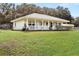 Charming one-story home with metal roof, front porch, and spacious lawn at 218 Ann St, Lady Lake, FL 32159