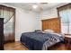 Spacious bedroom with large bed and wood floors at 218 Ann St, Lady Lake, FL 32159