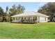 One-story house with metal roof, large yard, and covered porch at 218 Ann St, Lady Lake, FL 32159