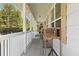Long front porch with white railings and wooden crate decor at 218 Ann St, Lady Lake, FL 32159