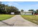 Long driveway leading to a single-story house with a storage shed at 218 Ann St, Lady Lake, FL 32159