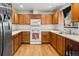 Efficient kitchen with wood cabinets, stainless steel appliances, and ample counter space at 218 Ann St, Lady Lake, FL 32159