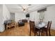 Living room with laminate floors, dining area, and a flat-screen TV at 218 Ann St, Lady Lake, FL 32159