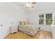 Bright bedroom with floral bedding and wood flooring at 1243 Tangerine Cir, Lady Lake, FL 32159