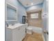 Updated bathroom, light blue walls, white vanity, and bathtub at 620 N Highland St, Mount Dora, FL 32757