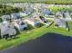 Aerial view showcasing a lakefront community with numerous houses at 4430 Seven Canyons Dr, Kissimmee, FL 34746