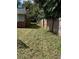 Side yard view showing a wooden fence and grassy area at 620 Gould St, Eustis, FL 32726