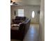 Living room with leather sofas, coffee table, and view of the front door at 620 Gould St, Eustis, FL 32726