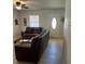 Cozy living room featuring brown leather couches and a wood-look floor at 620 Gould St, Eustis, FL 32726