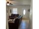 Living room with leather sofas, coffee table, and view of the front door at 620 Gould St, Eustis, FL 32726