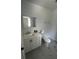 Bathroom with white vanity, toilet and marble-look floors at 620 Gould St, Eustis, FL 32726