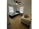 Bright bedroom with two twin beds, ceiling fan, and light wood flooring at 620 Gould St, Eustis, FL 32726