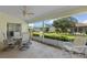 Spacious screened patio with outdoor seating and backyard view at 5729 King James Ave, Leesburg, FL 34748