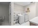Bright laundry room with storage and sink at 5729 King James Ave, Leesburg, FL 34748