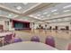 Large community room with hardwood floors, stage, and ample seating at 5729 King James Ave, Leesburg, FL 34748