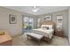 Main bedroom with a king-size bed and sliding door access to the patio at 5729 King James Ave, Leesburg, FL 34748