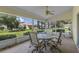 Relaxing screened patio with seating area, ceiling fan, and view of backyard at 5729 King James Ave, Leesburg, FL 34748