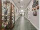 Building hallway showcasing artwork and a display cabinet at 5729 King James Ave, Leesburg, FL 34748