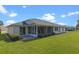 Single-story home with screened patio and well-maintained lawn at 5729 King James Ave, Leesburg, FL 34748