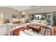 Bright and airy living room featuring a comfortable sectional sofa and access to backyard at 5729 King James Ave, Leesburg, FL 34748