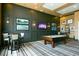 Game room with pool table, bar seating, and big screen TV at 518 Narrow View Ln, Groveland, FL 34736