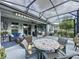 Large screened patio with multiple seating areas for entertaining at 518 Narrow View Ln, Groveland, FL 34736