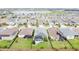 Aerial view of homes with solar panels and lush landscaping at 518 Narrow View Ln, Groveland, FL 34736
