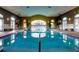 Indoor swimming pool with large windows and seating at 518 Narrow View Ln, Groveland, FL 34736
