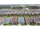 Aerial view showcasing a neighborhood with houses and a tree-lined area at 518 Narrow View Ln, Groveland, FL 34736