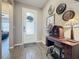 Entryway with wood-look floors and vintage decor at 518 Narrow View Ln, Groveland, FL 34736