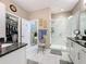 Spa-like bathroom with a walk-in shower, double vanity, and large closet at 518 Narrow View Ln, Groveland, FL 34736