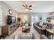 Spacious living room with a leather couch and large TV at 518 Narrow View Ln, Groveland, FL 34736