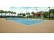 Outdoor tennis court with tan surface and net at 518 Narrow View Ln, Groveland, FL 34736
