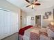 Bright bedroom with a queen-size bed and double door closet at 518 Narrow View Ln, Groveland, FL 34736