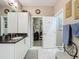 Modern bathroom with granite countertops, walk-in closet, and white cabinets at 518 Narrow View Ln, Groveland, FL 34736