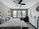 Spacious primary bedroom with king-size bed and plenty of natural light at 518 Narrow View Ln, Groveland, FL 34736