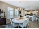 Bright dining room features a round table and chairs, perfect for gatherings at 518 Narrow View Ln, Groveland, FL 34736