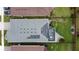 Aerial view of a home with solar panels and a patio at 518 Narrow View Ln, Groveland, FL 34736