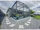 Screened patio with paver stones pathway, creating a welcoming outdoor space at 518 Narrow View Ln, Groveland, FL 34736