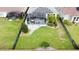 Expansive backyard oasis featuring a covered patio and solar panels at 518 Narrow View Ln, Groveland, FL 34736