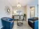 Elegant sitting area with two blue armchairs and a stylish console table at 518 Narrow View Ln, Groveland, FL 34736
