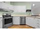 Kitchen with stainless steel appliances and white cabinetry at 1020 Hilltop Rd, Tavares, FL 32778