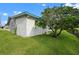 Side view of the house showcasing landscaping at 1020 Hilltop Rd, Tavares, FL 32778