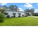 Another view of the house with green grass at 1020 Hilltop Rd, Tavares, FL 32778
