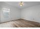 Spacious bedroom with wood-look flooring and ceiling fan at 1020 Hilltop Rd, Tavares, FL 32778