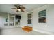 Covered porch with ceiling fan, screen enclosure, and wood steps at 1020 Hilltop Rd, Tavares, FL 32778