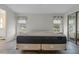 Main bedroom with wood-look floors and two windows with window treatments at 1020 Hilltop Rd, Tavares, FL 32778