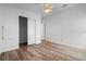 Bright bedroom with wood-look flooring and sliding closet doors at 1020 Hilltop Rd, Tavares, FL 32778