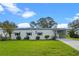 Front view of the house with a neat lawn at 1020 Hilltop Rd, Tavares, FL 32778