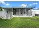 Screened porch with a white picket fence at 1020 Hilltop Rd, Tavares, FL 32778
